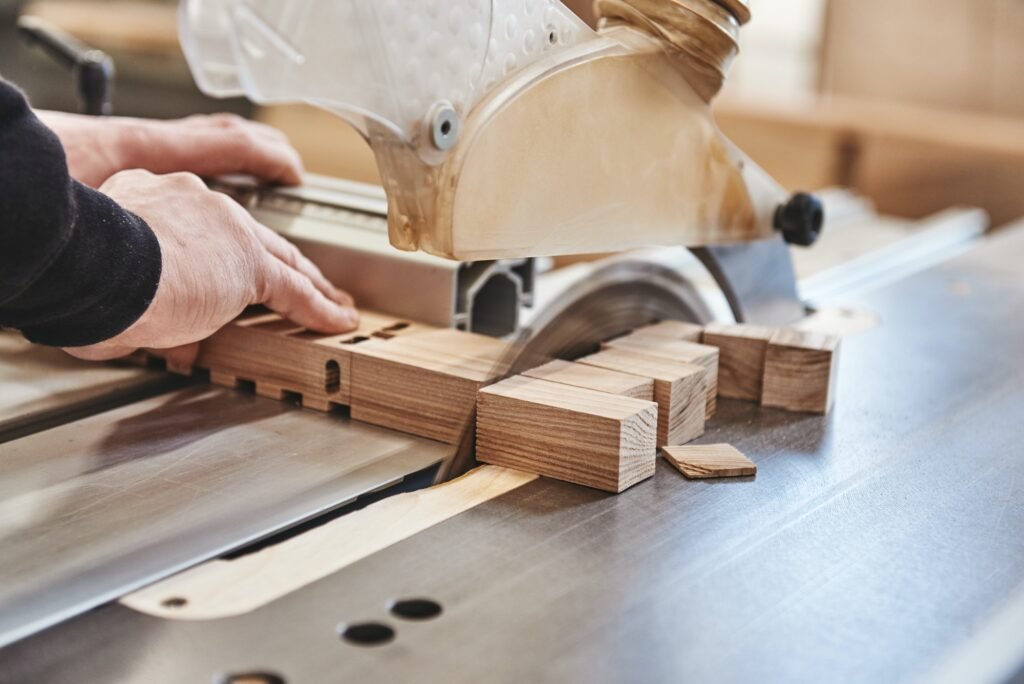 Carpenter working with industrial tool in wood factory