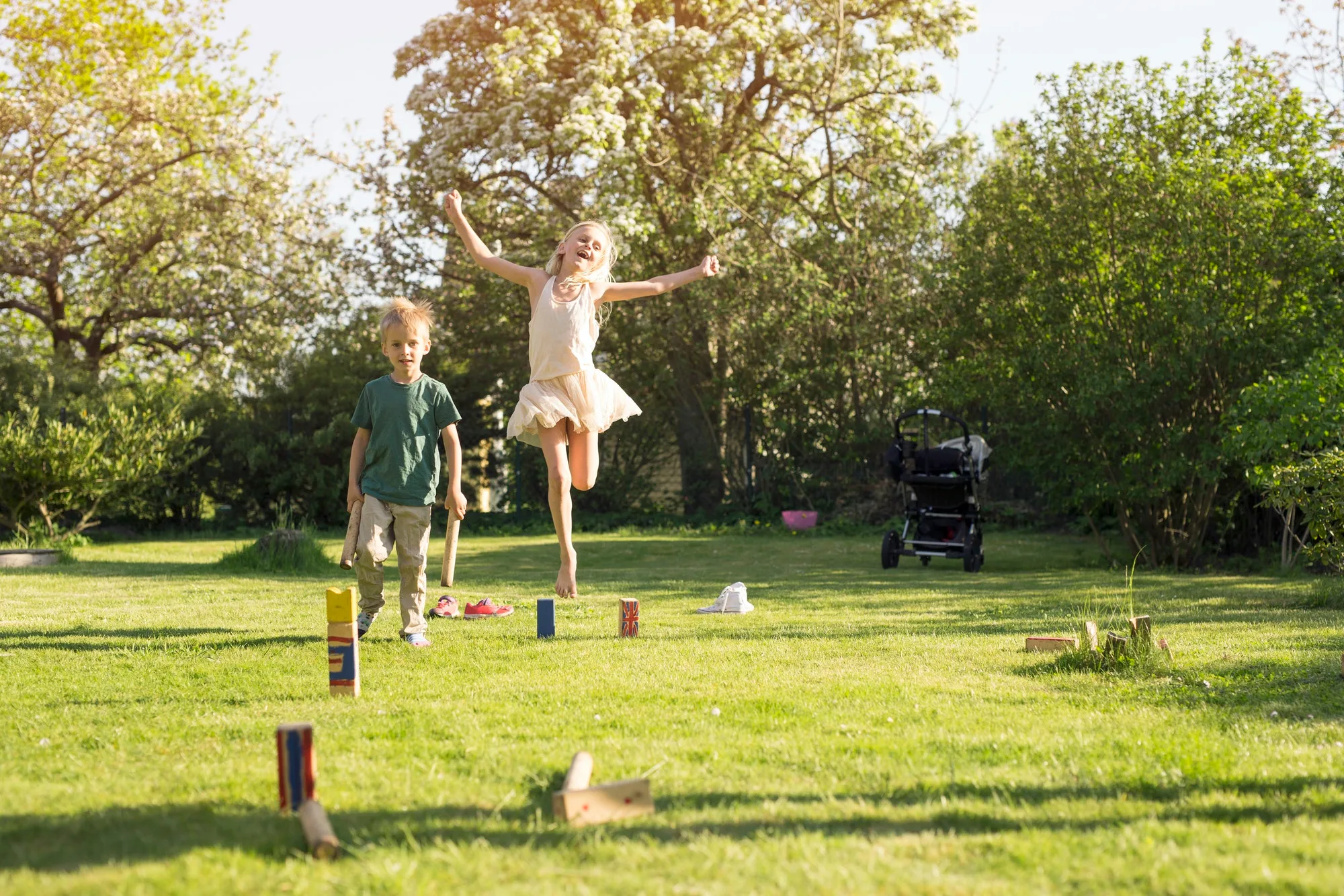 Children (4-5, 8-9) playing Kubb