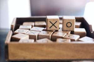 Closeup image of wooden Tic Tac Toe game or OX game in a box