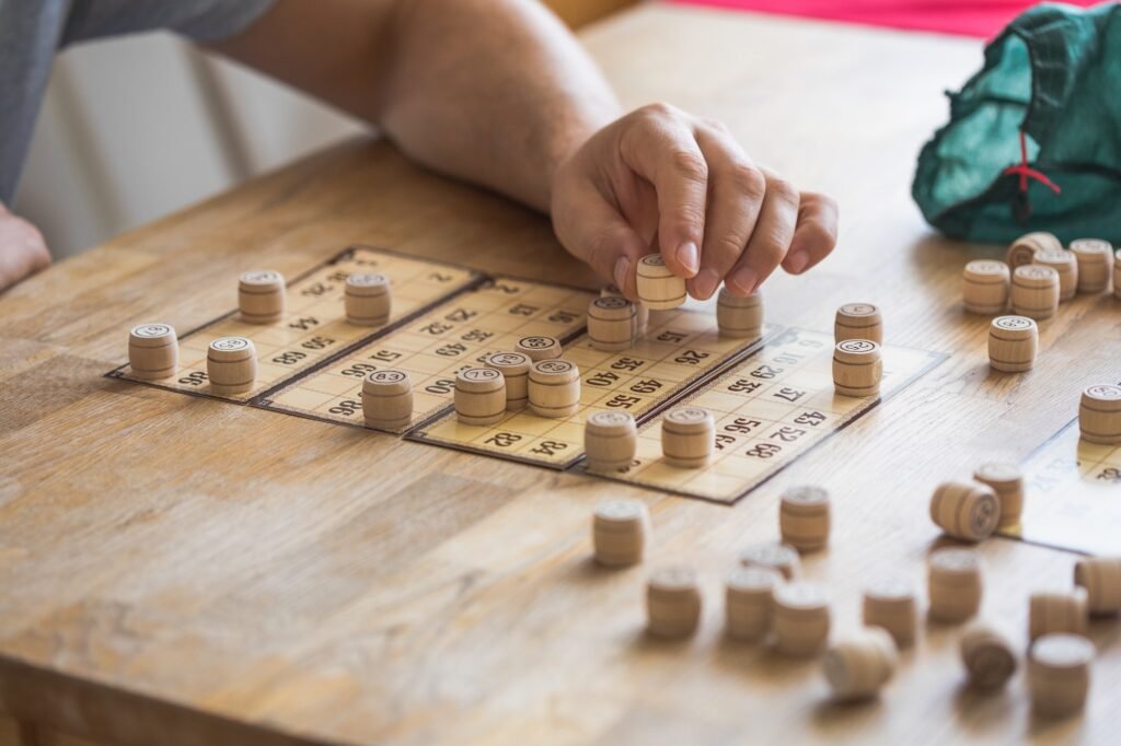 People play Russian loto on the table. Game of kegs with numbers